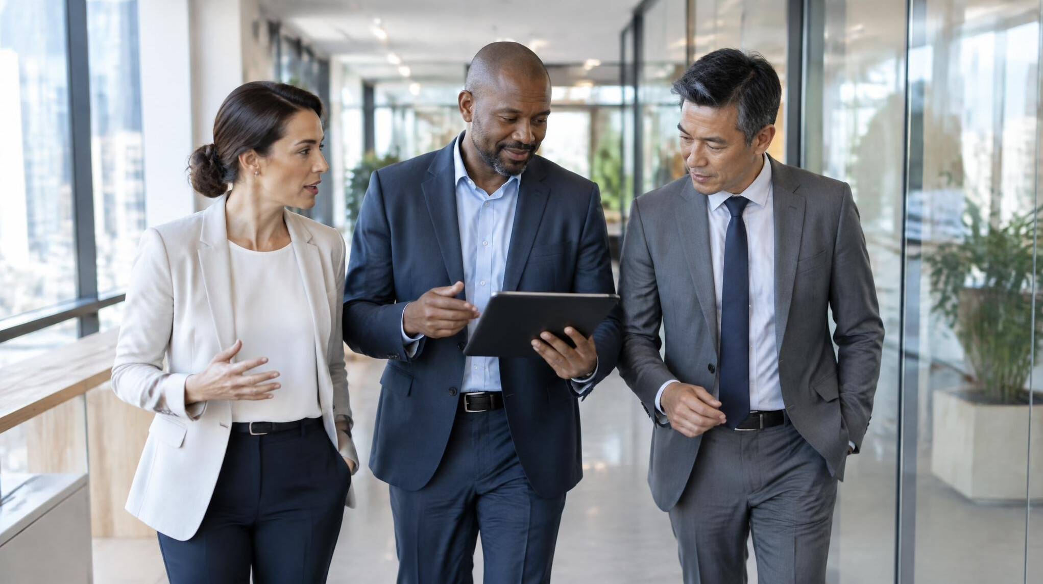 Leadership team walking through an office corridor in discussion